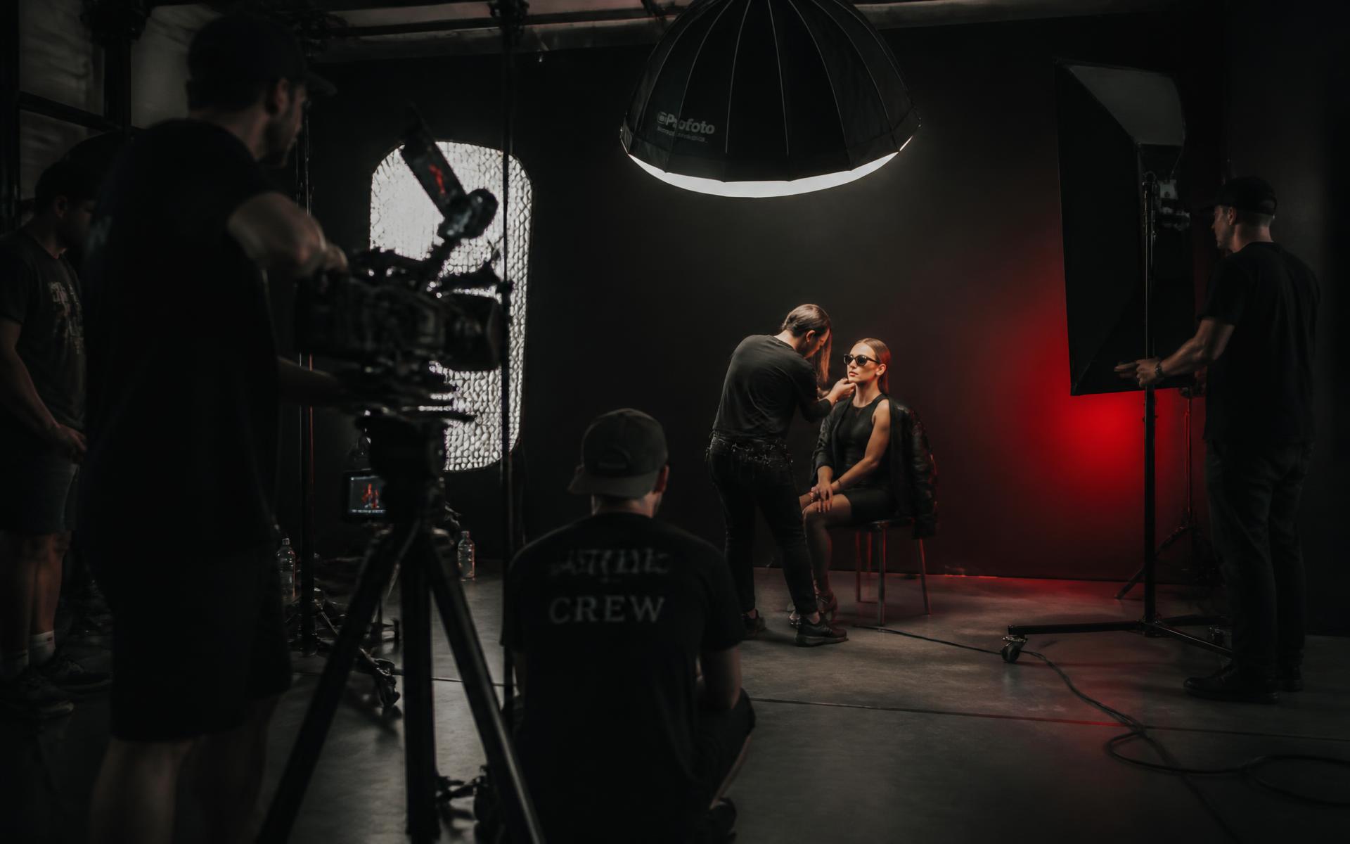 Athlete on a dark commercial photo shoot set with red lighting